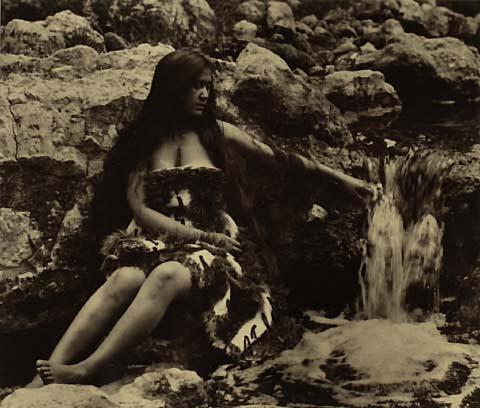Maori woman beside stream (II)